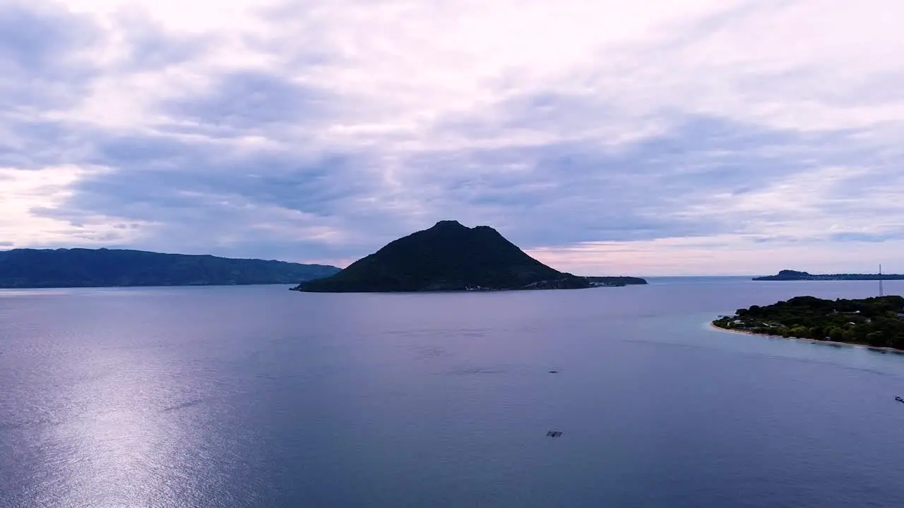 Aerial drone of remote tropical island within a colourful hazy cloudy sunset in Alor Island East Nusa Tenggara Indonesia