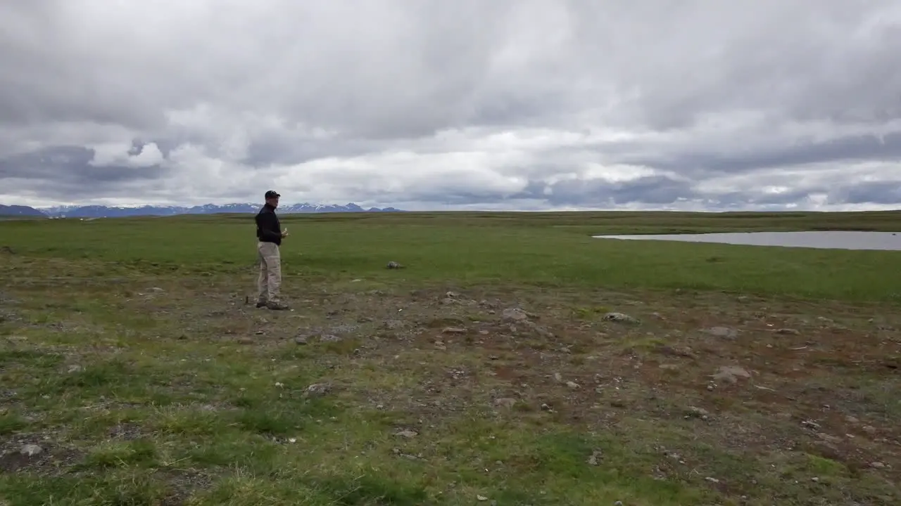 Iceland Man Standing Under Cloudy Sky