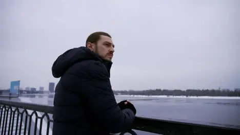 Long-haired guy outdoors in a cold day