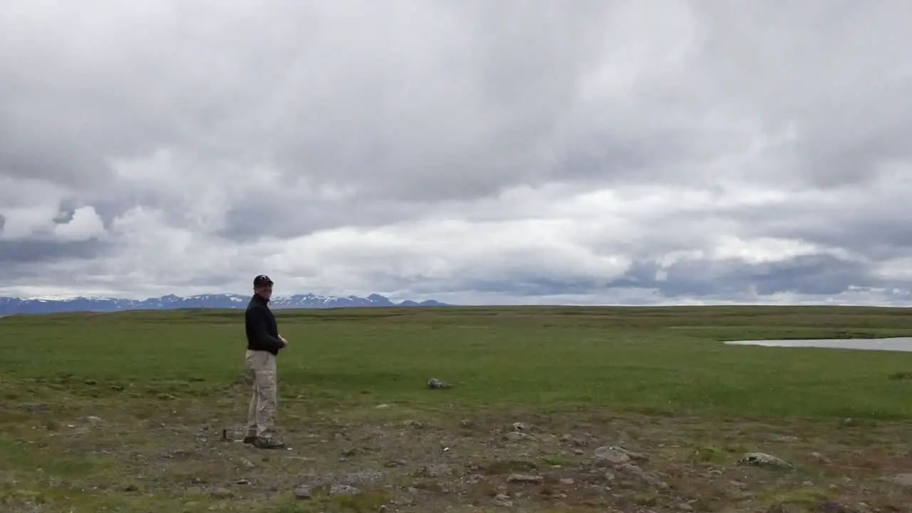 Iceland Man Standing Under Cloudy Sky Pan