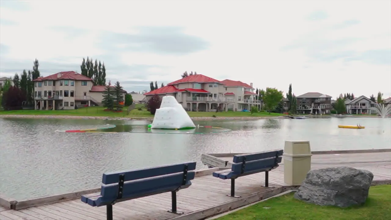 Private lake and beach in a private nice neighbourhood with benches on an overcast day