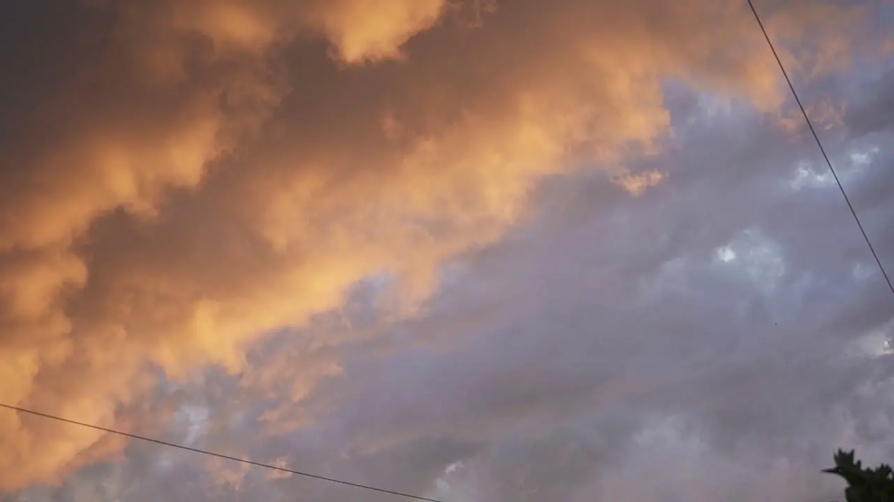 Beautiful sunset in the sky with orange and teal clouds