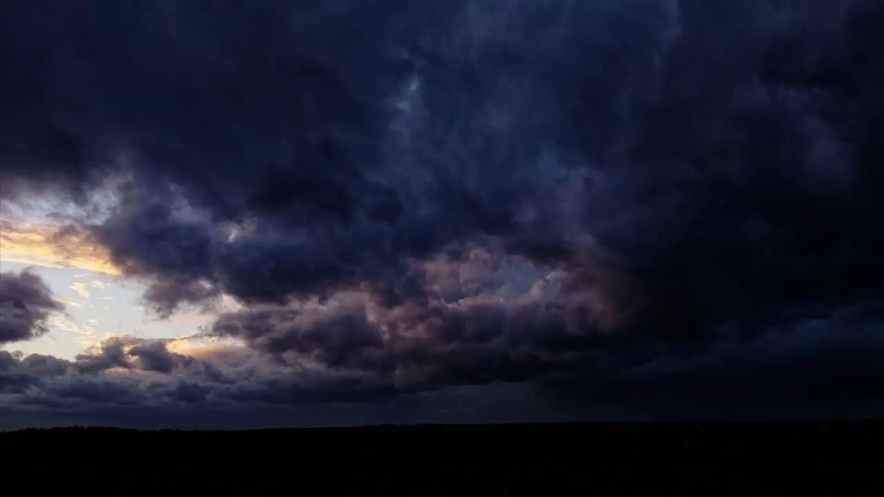 By drone over a stormy sky with dark and threatening clouds illuminated by lightning giving the impression of a coming storm offering an intense and striking aerial view of the storms