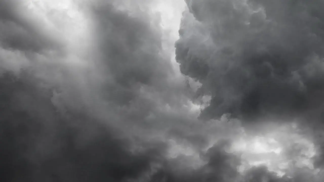 view of flying through gray cumulonimbus clouds in the dark sky