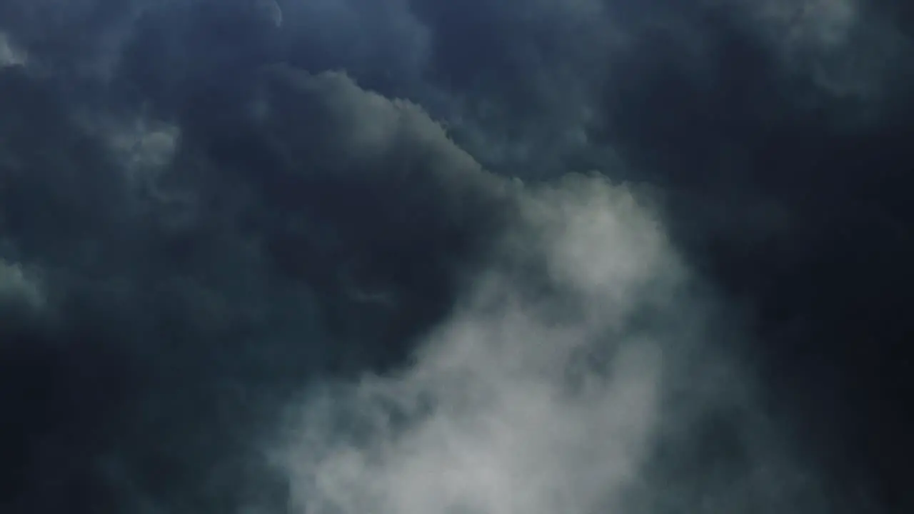 4k thunderstorm flying through dark cumulonimbus clouds in moving sky