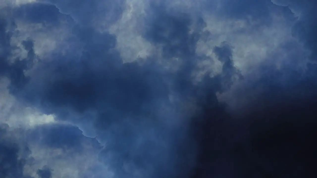 a thunderstorm a flash of lightning flashing across a dark sky with moving clouds