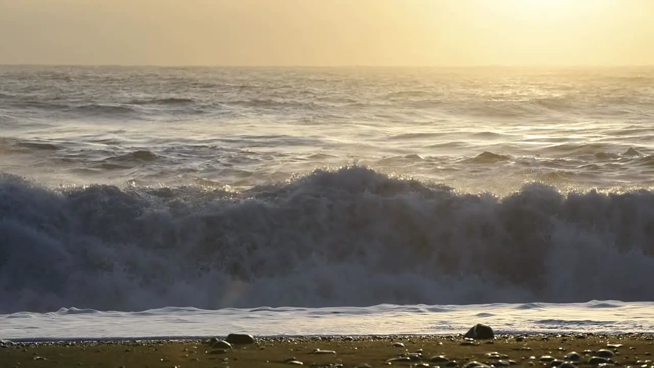 A Rough winter sea with waves crashing on a black beech in Iceland