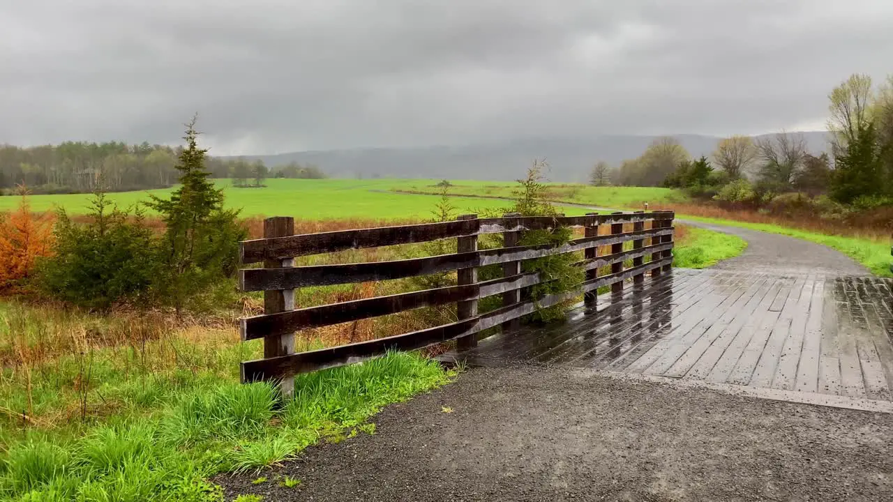 A beautiful wooden pedestrian footbridge in grasslands in the Appalachian mountains