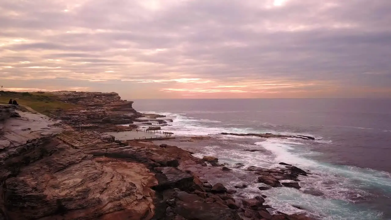 Aerial shot of velvet sunrise at the beach in a cloudy windy morning