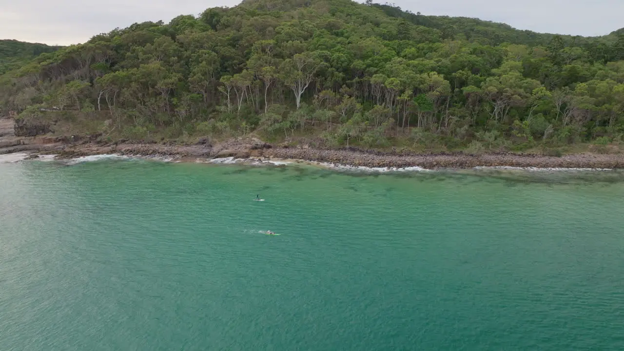 Scenic Aerial Drone Of Athlete Ocean Swimming Offshore With Stand Up Paddle Boarder 4K Noosa Australia Slow Motion