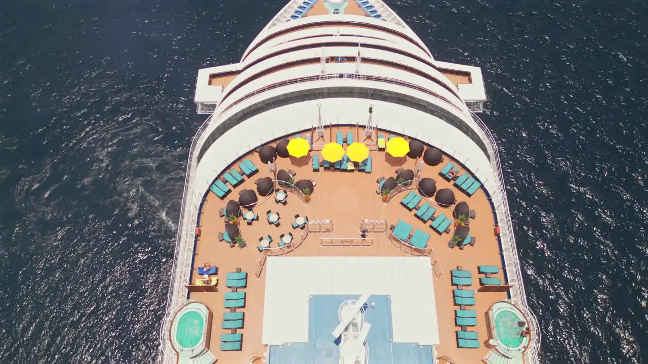 An aerial drone flies overhead of a cruise ship anchored in the bay of Cabo San Lucas Mexico