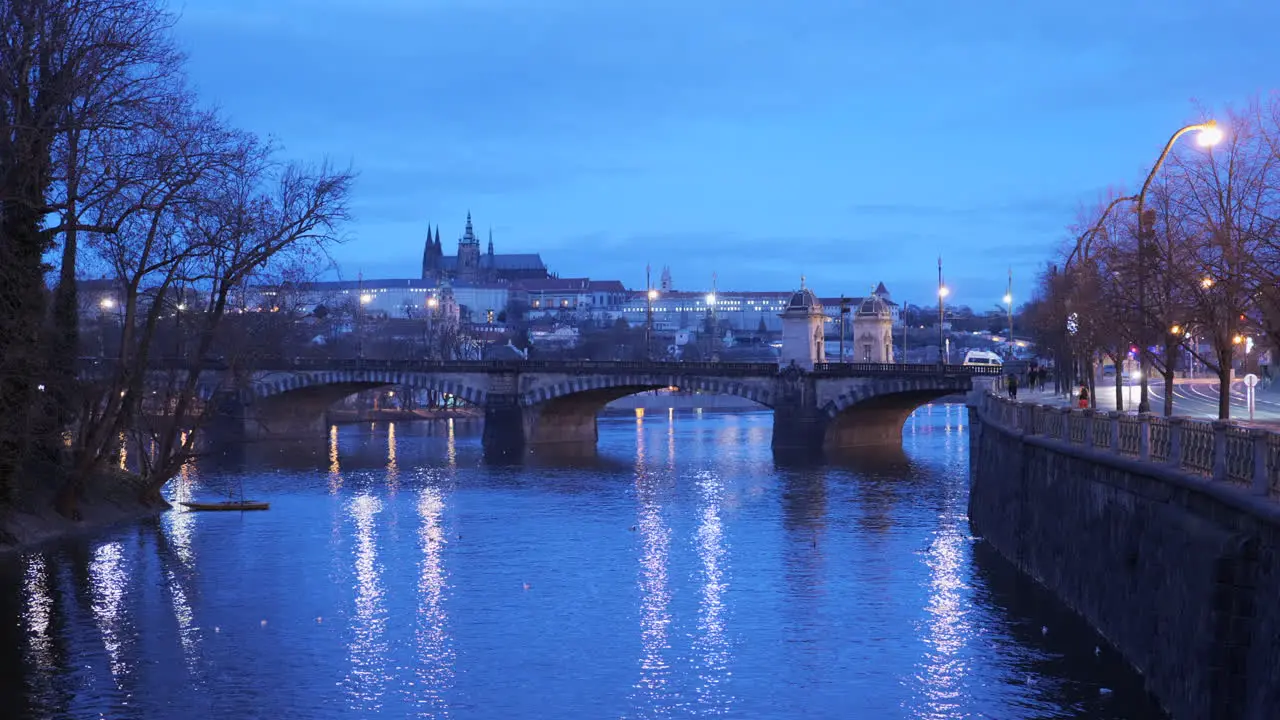 Blue hour distant view of Prague castle with bridge in the foreground during early morning