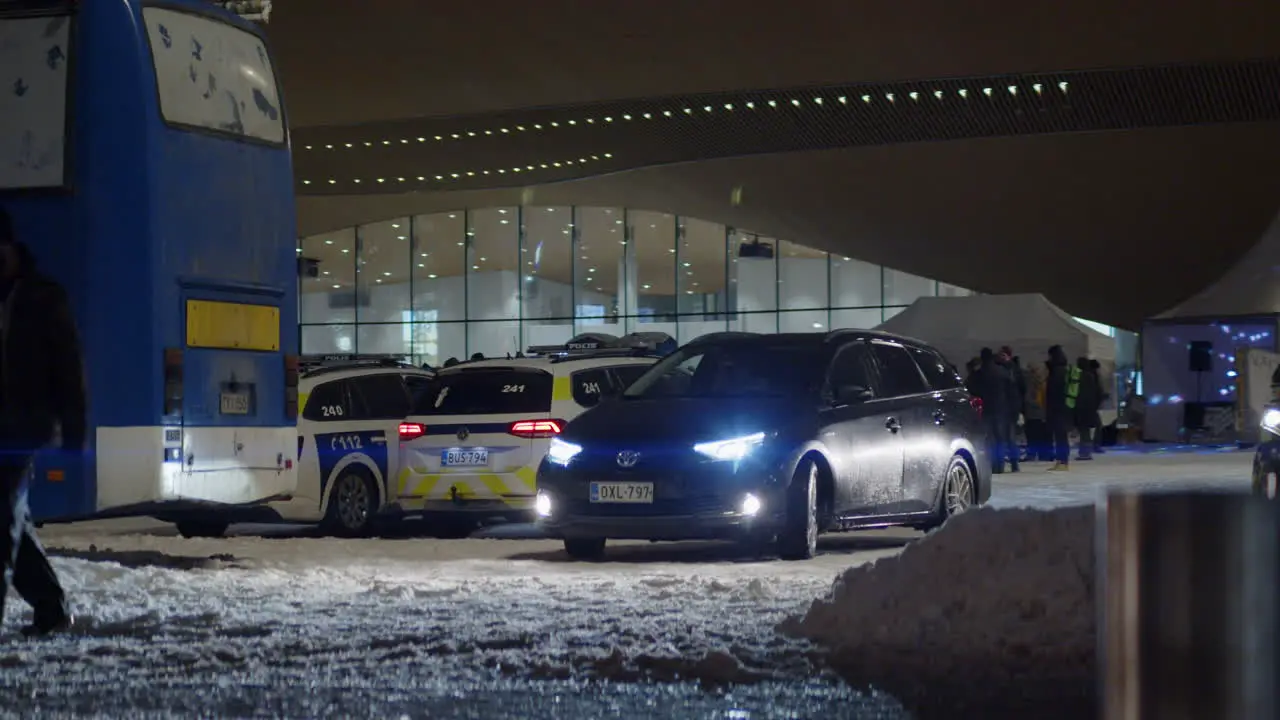 View of a black car in benn parked outside a hall