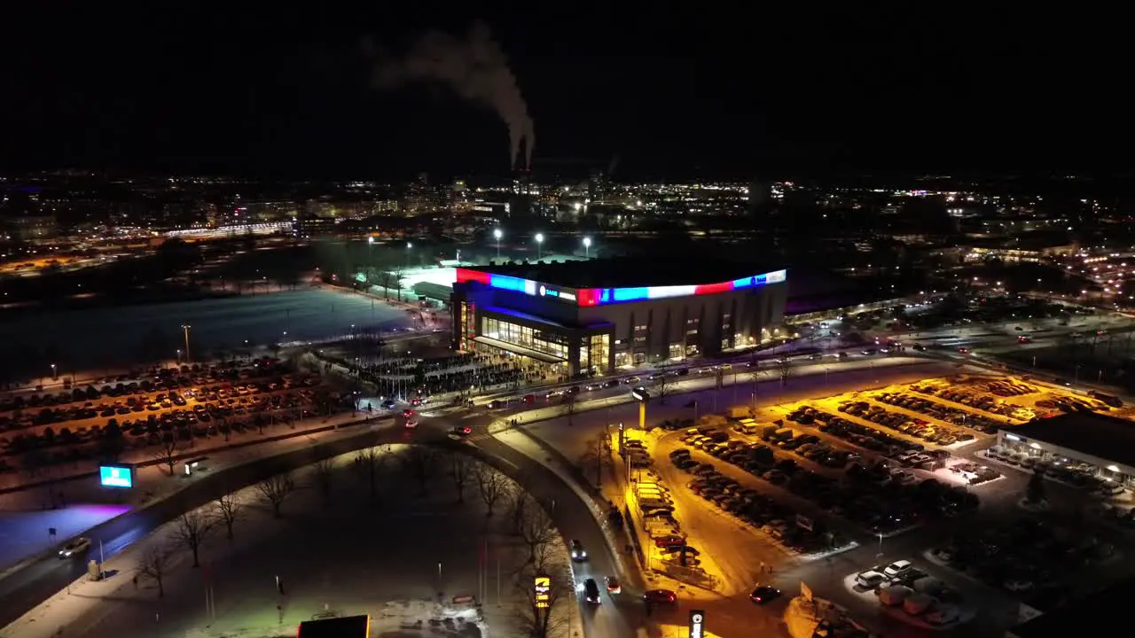 Aerial Circulating around Saab Arena in Linköping Sweden before LHC hockey match People entering and queueing Winter night