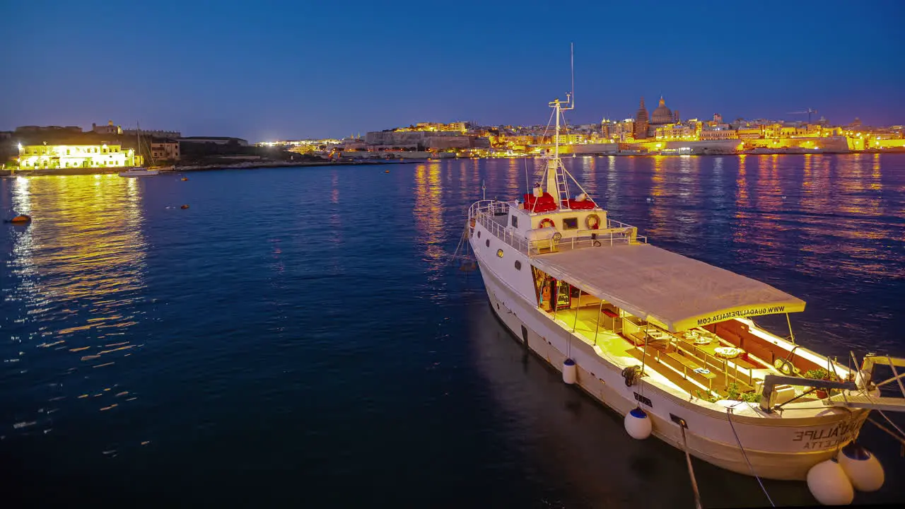 Night Timelapse of Anchored Boat in Bay Valletta Malta Distant Lights Across Bay