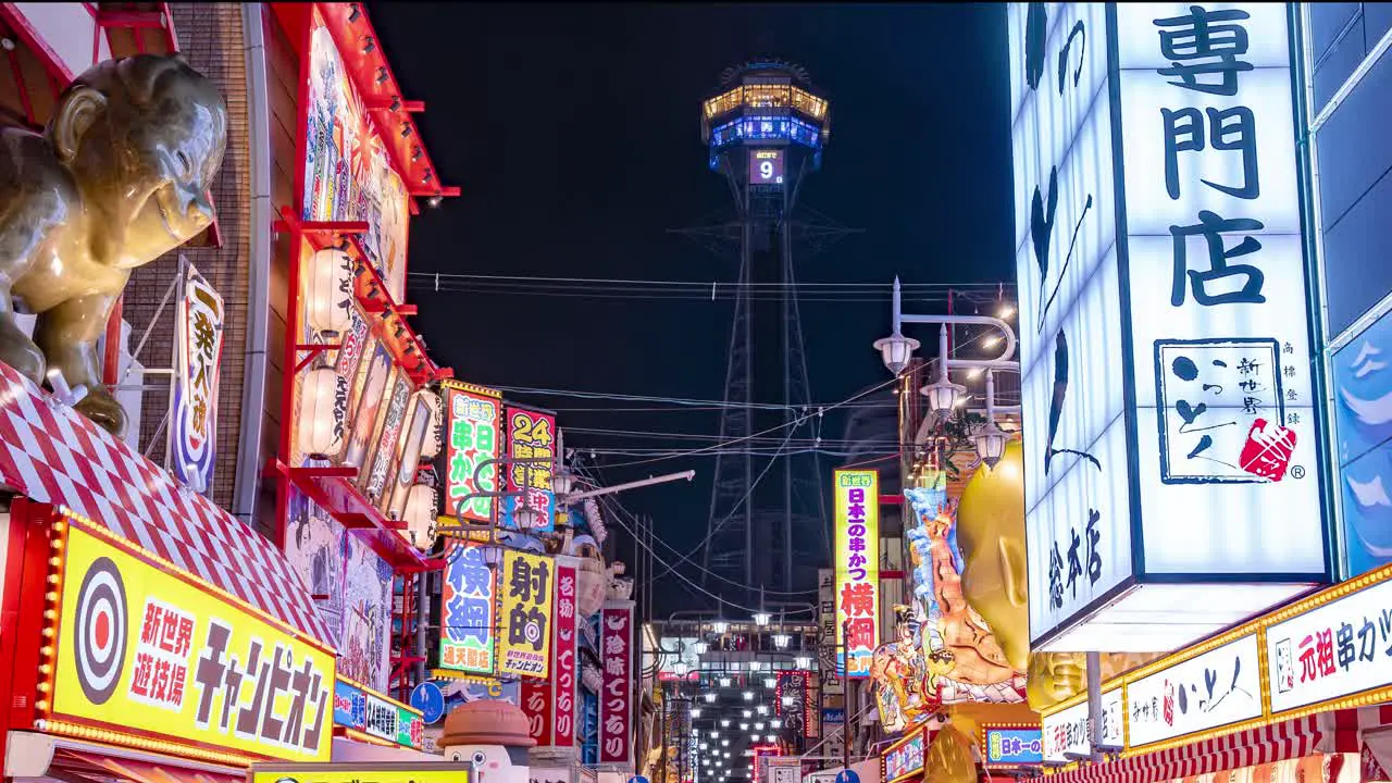 Time lapse of Osaka by Night Tsutenkaku Tower with Crowds and city lights at the vibrant Ebisu Higashi District