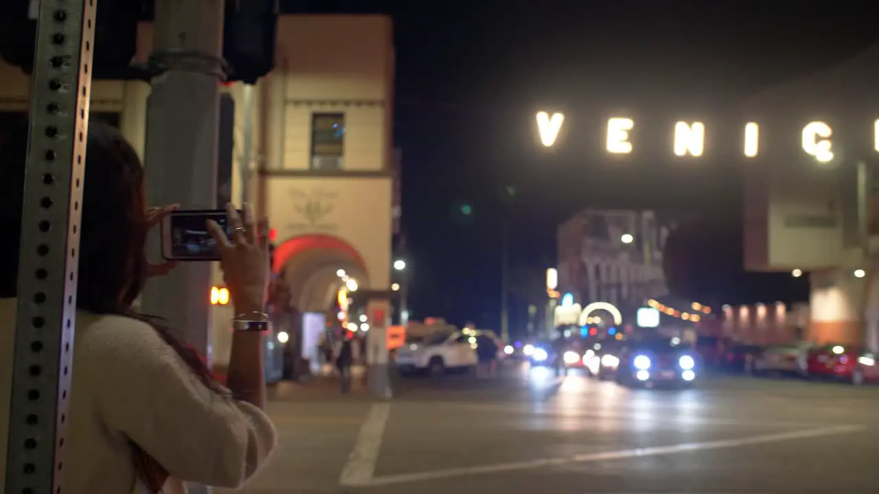 Woman Photographing Venice Sign