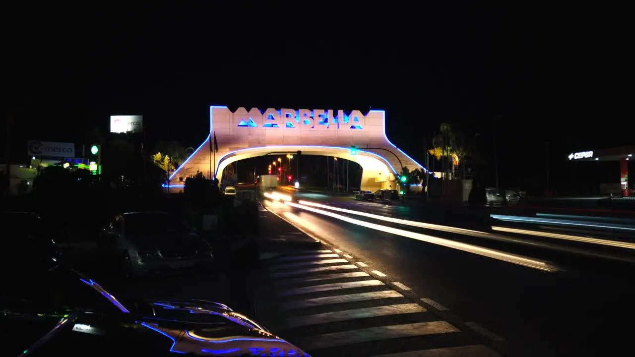 marbella arch sign at night motion hyperlapse with light streaks from cars