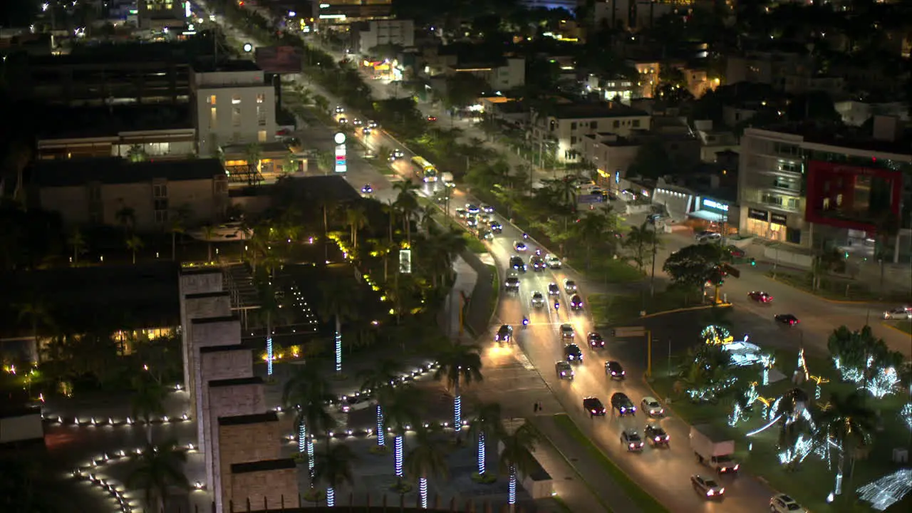 Aerial view of Cancun Mexico at night with cars driving by on Av