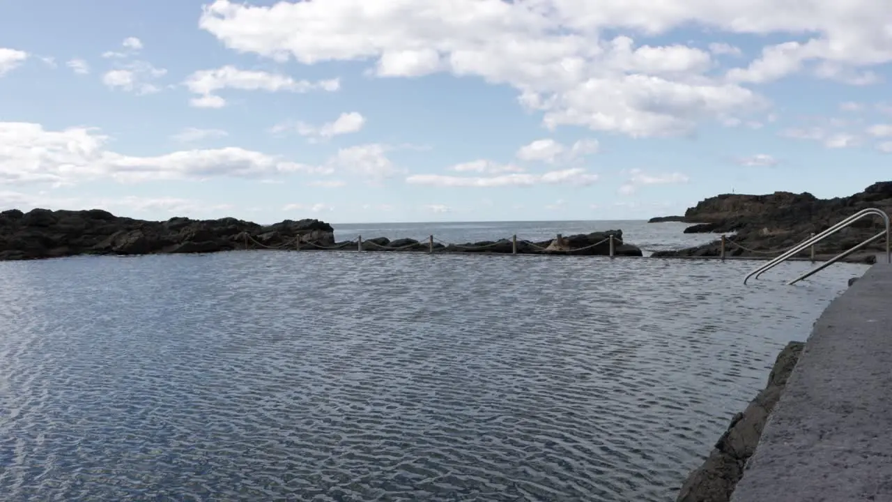 Ocean pool in Kiama Beach in New South Wales Australia with ladder on cloudy day Locked shot