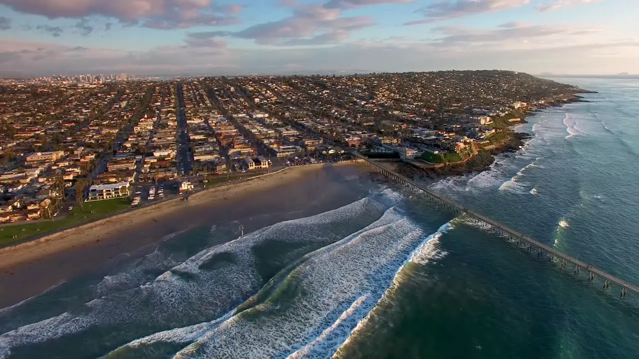 California pier and beach town coastline in San Diego Ocean Beach huge blue turquoise Pacific Ocean waves rolling tide