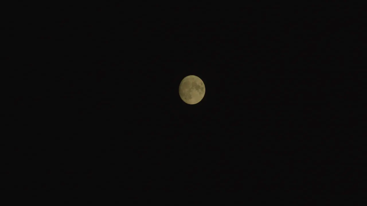 Moon moves sloly in the clear sky