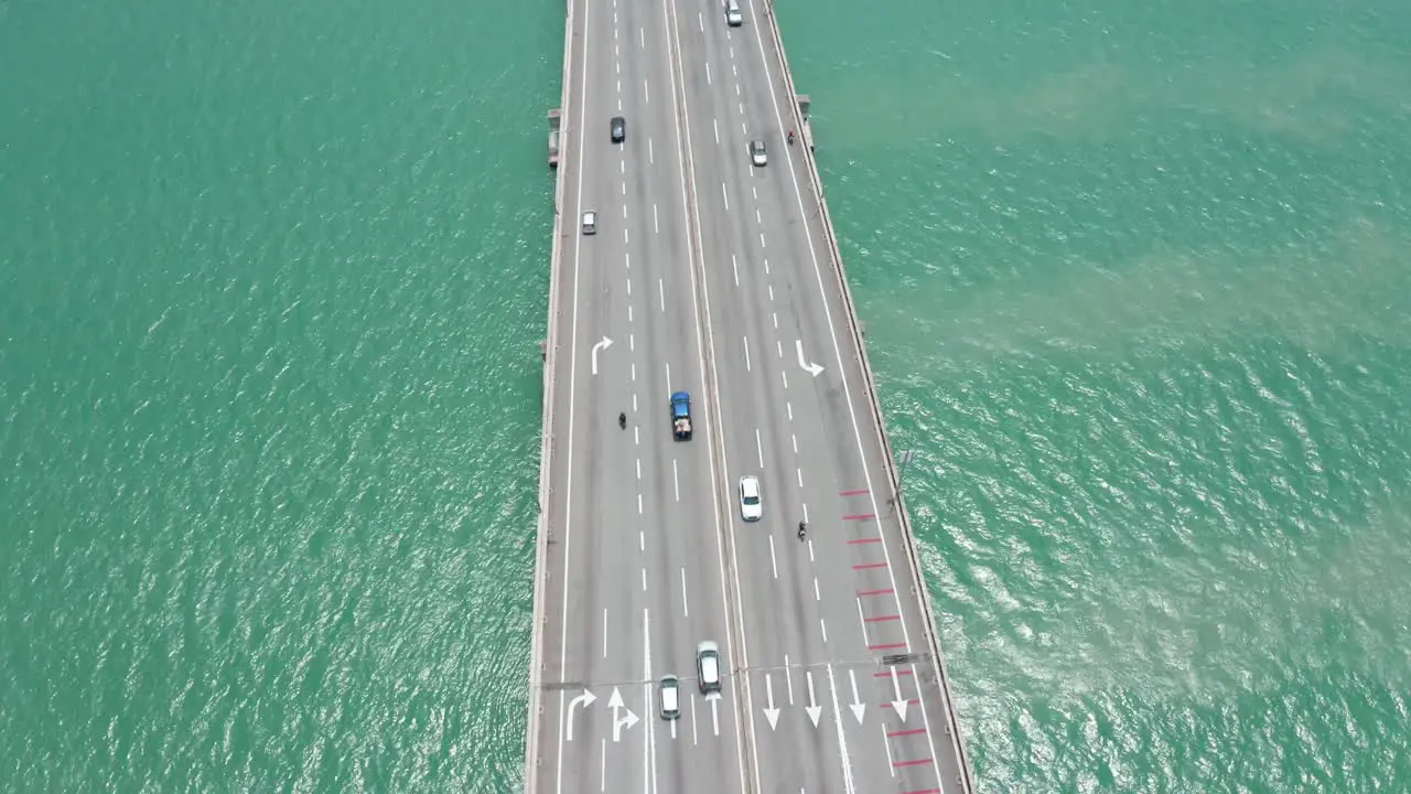 Aerial view of Penang Bridge Malaysia with traffic lanes in both directions drone bird's eye view orbit shot