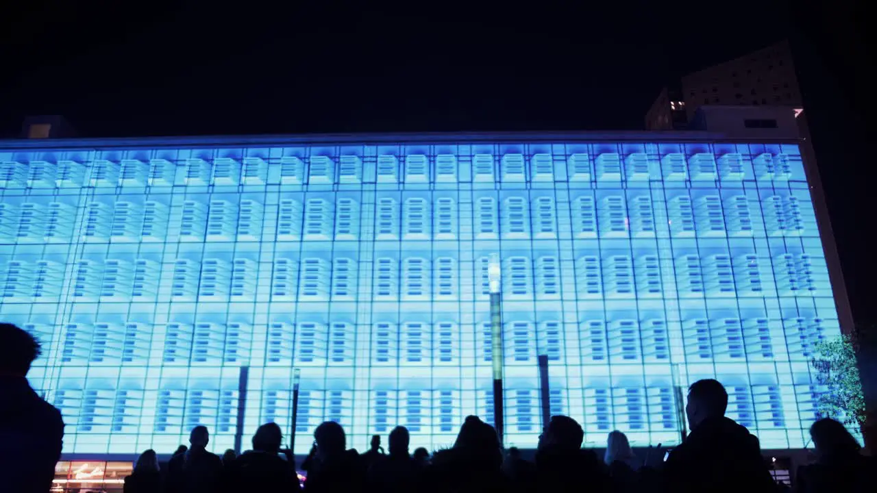 Colorful light show on exterior wall of large building in the Netherlands