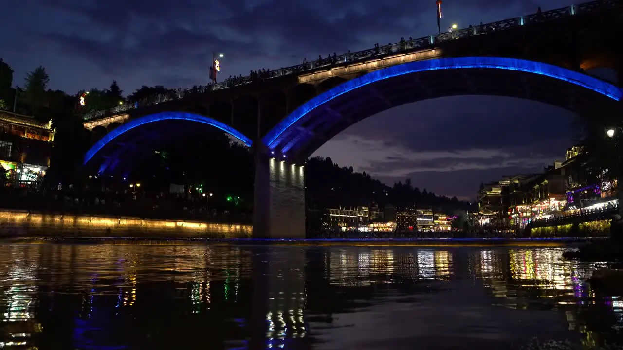 Old historic arched road bridge over Tuo river flowing through the centre of Fenghuang Old Town China