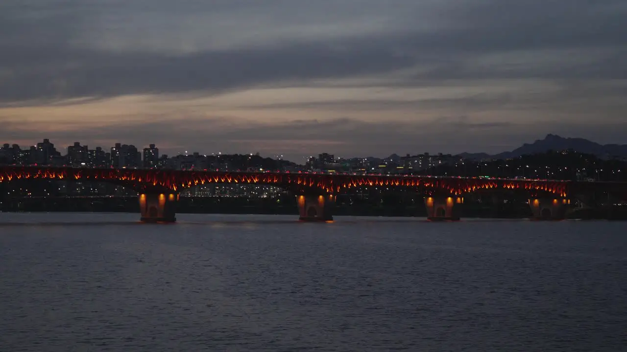 Seongsu Bridge crossing Han River with Seoul buildings in background at night