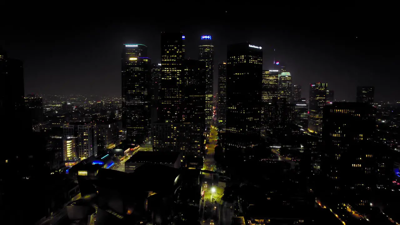 Aerial shot of Downtown Los Angeles at night with skyscrapers on the skyline