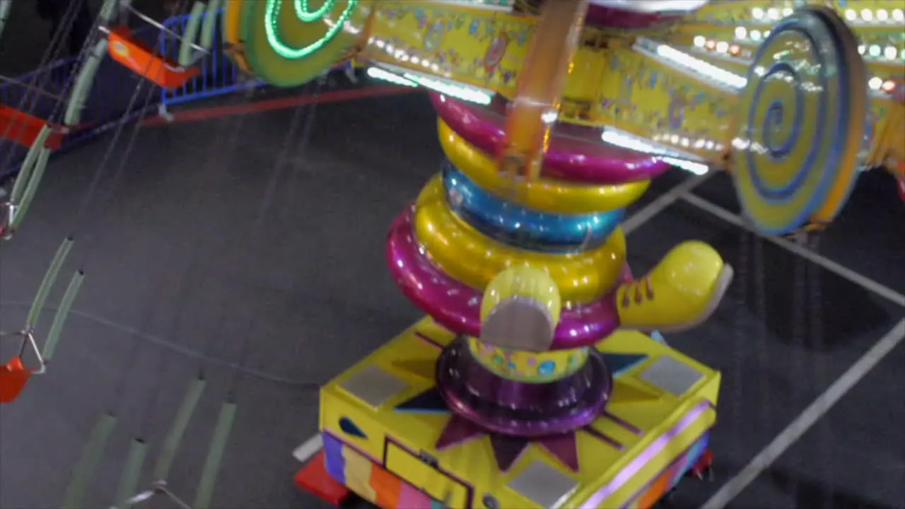 Carnival Clown Spinning Ride Overhead View in the Evening