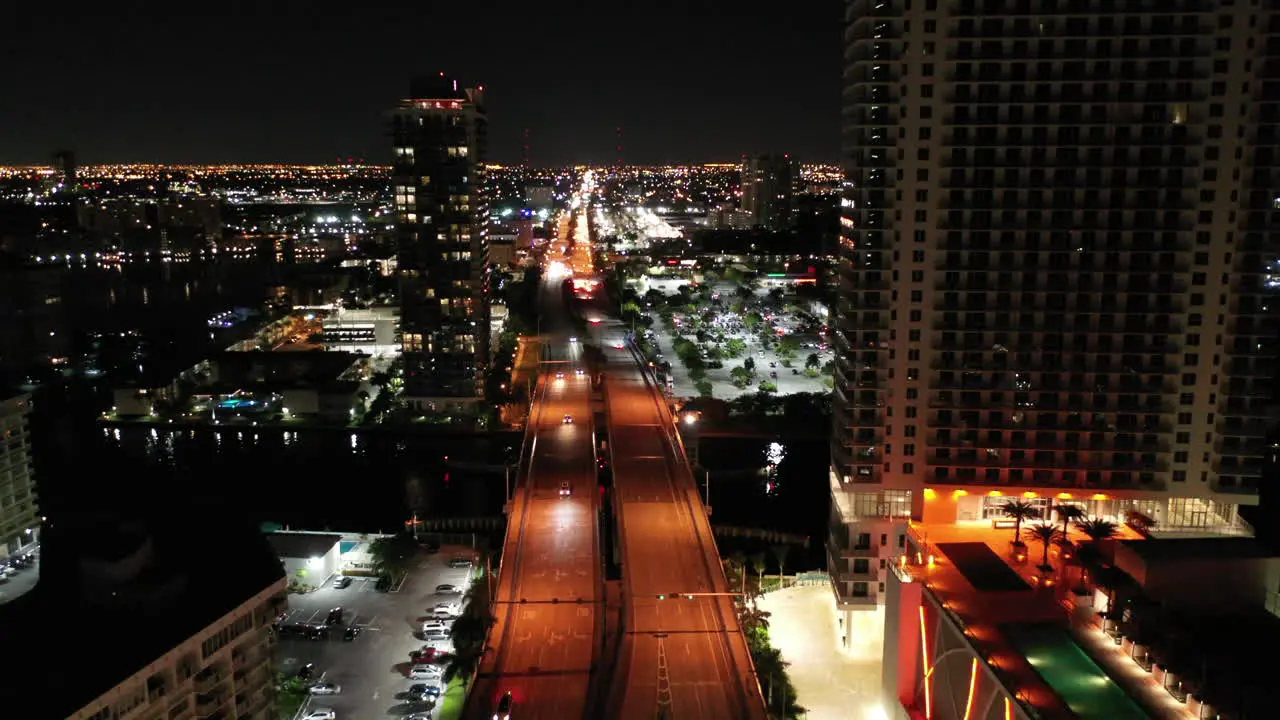 An aerial tilt of nighttime city view over streets in Miami