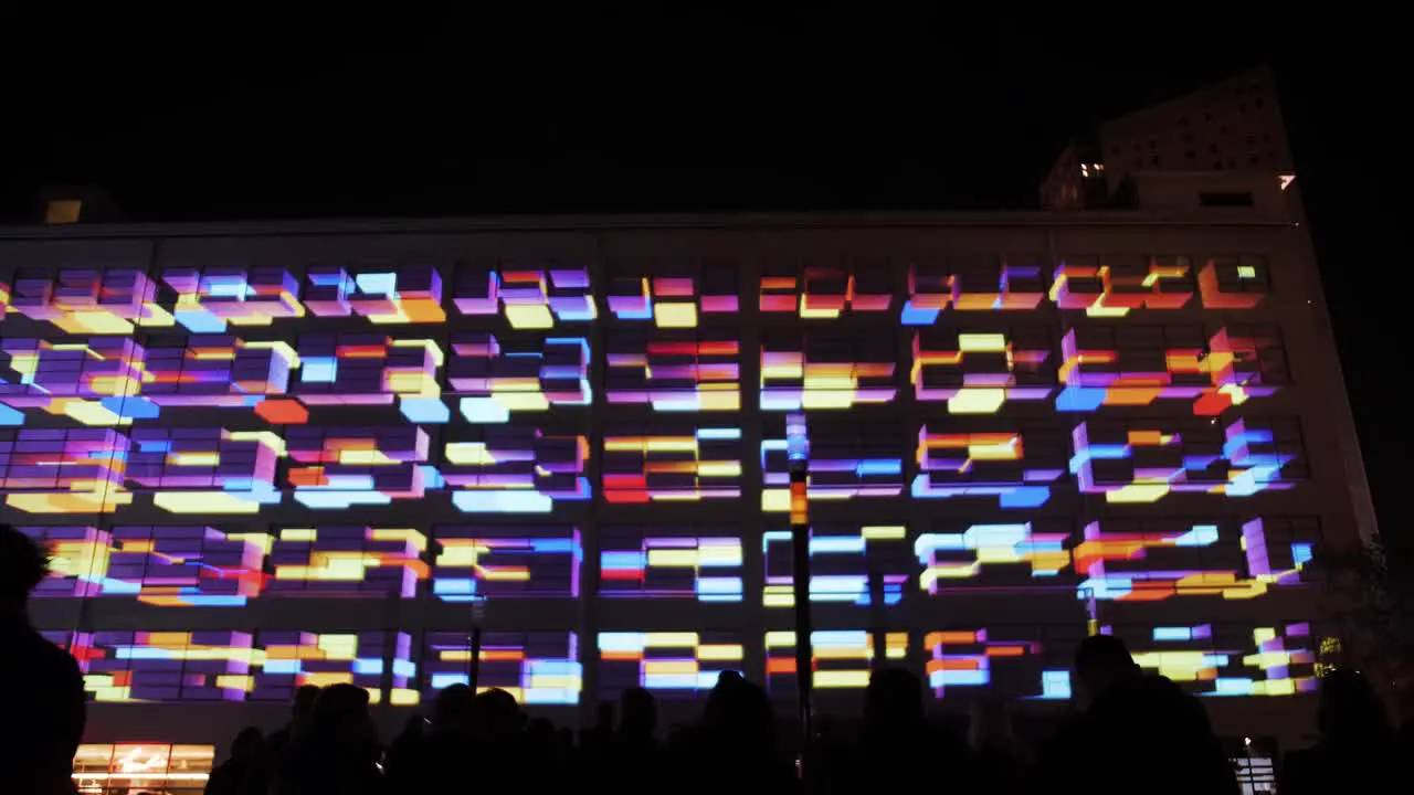 Colorful light show on building’s exterior wall at nighttime event in Eindhoven Netherlands