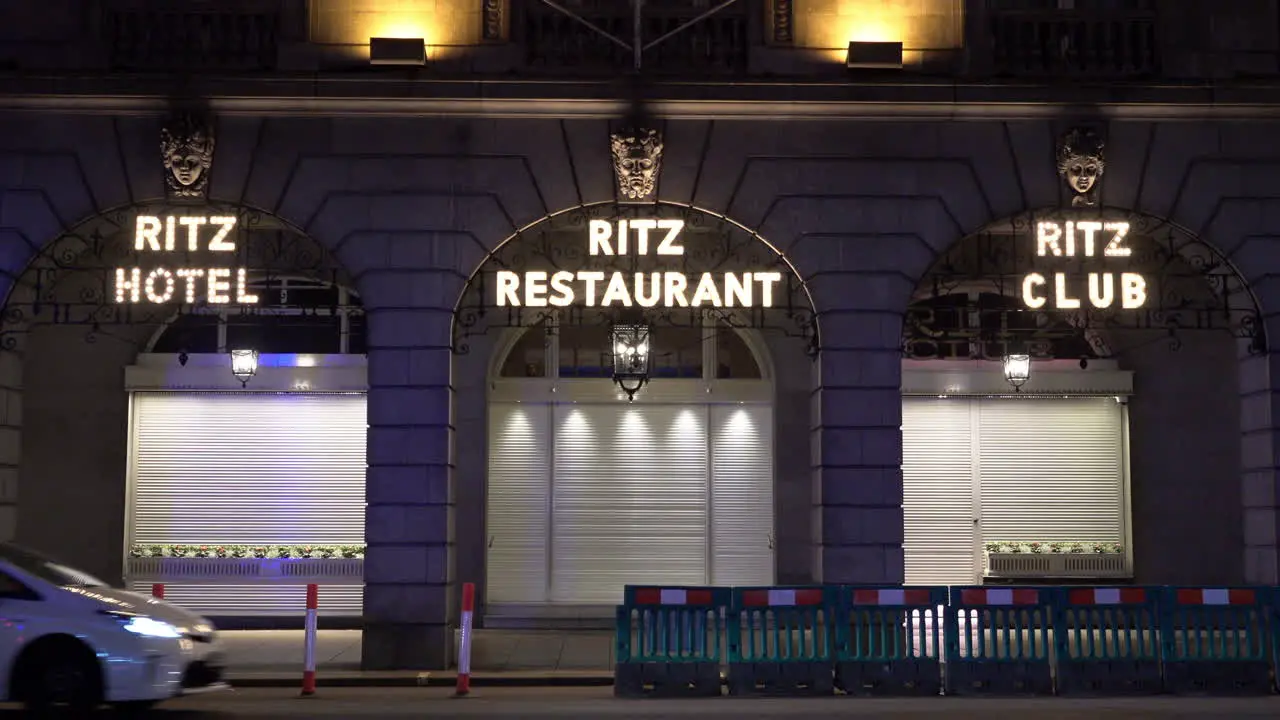 A police van speeds past the closed shutters on the Ritz hotel club and restaurant in London at the start of the second national lockdown designed to reduce the Coronavirus infection rate