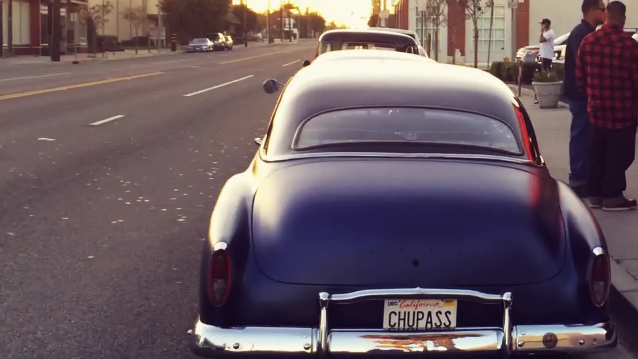 A lowrider in the street at sunset