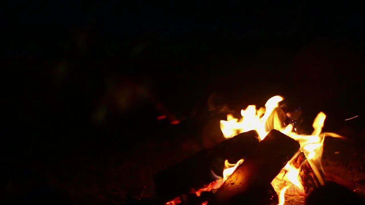 Camp fire burning crackling and popping at night