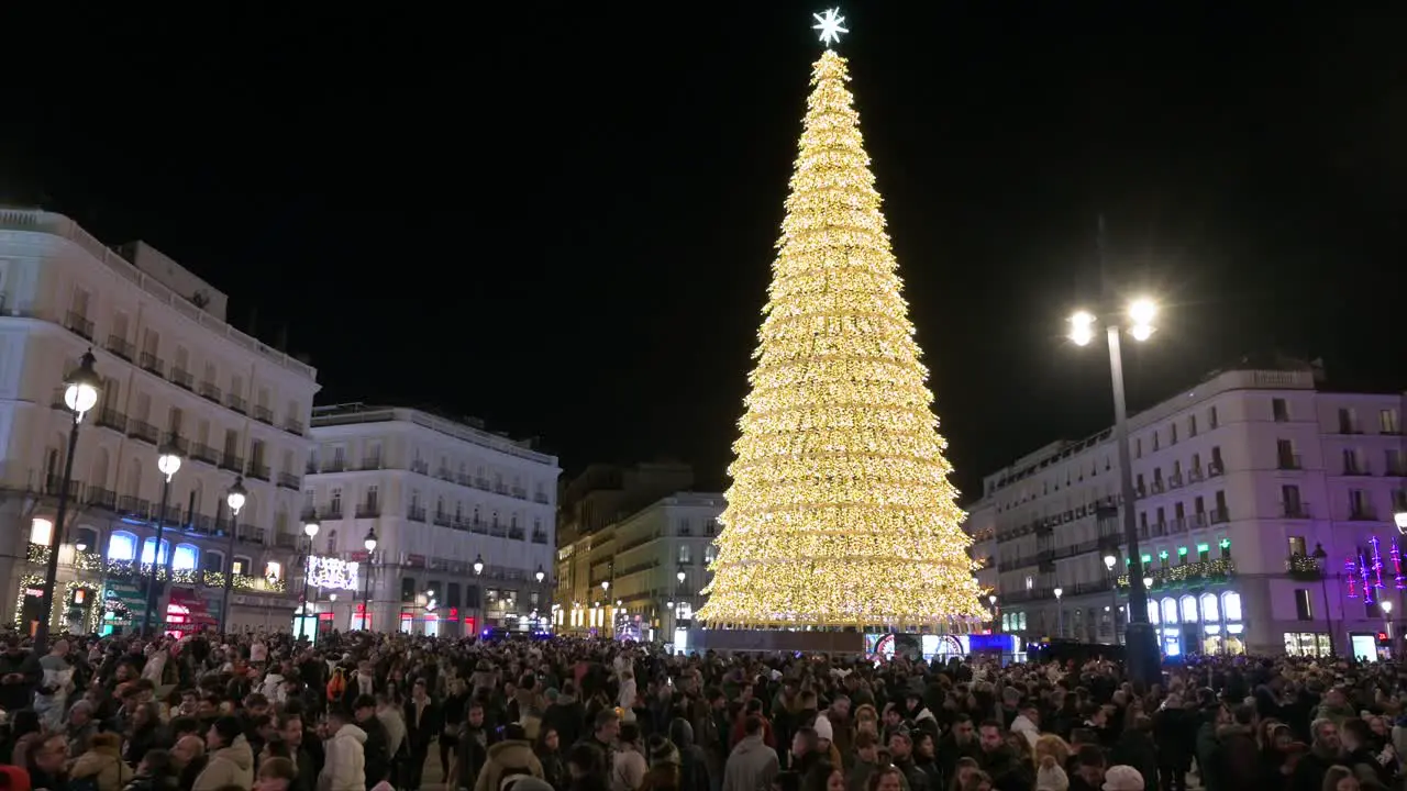 An illuminated Christmas tree installation decorated with gold LED lights during the Christmas season at Puerta del Sol Square in Madrid