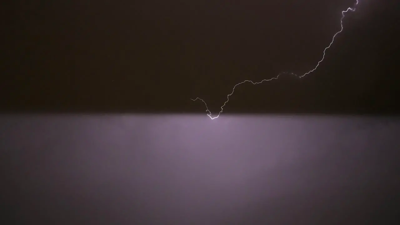 Streak of lightning flashes in the night sky in Madrid Spain