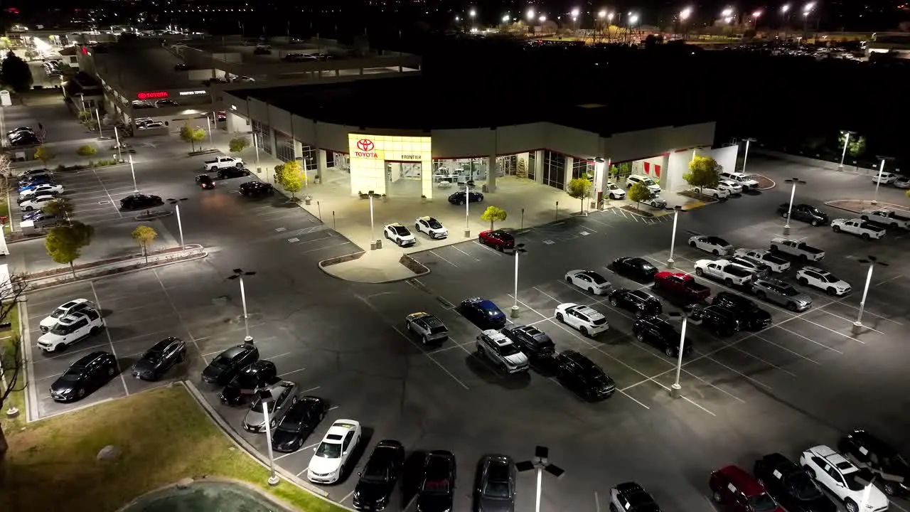 Toyota car dealership nighttime aerial flyover