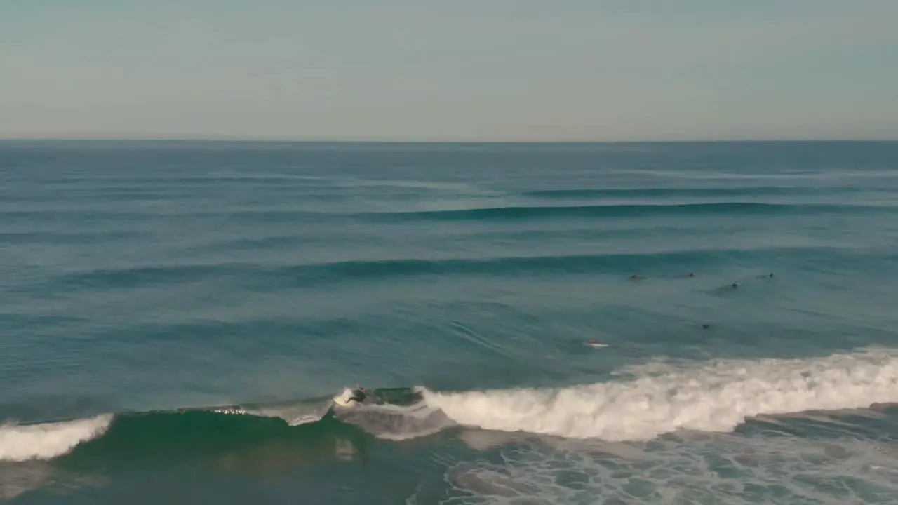 Aerial of a man surfing very fast for the very fast with medium level