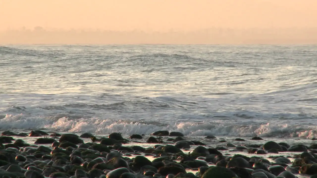 Pan of a wave breaking at Surfers Point in Ventura California