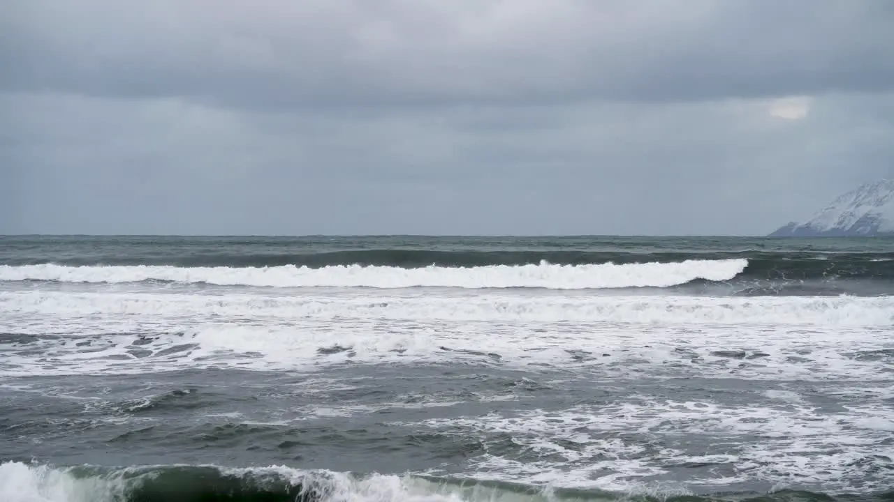 Cold winter day in the Arctic crashing waves after a storm in North Island static slow motion shot