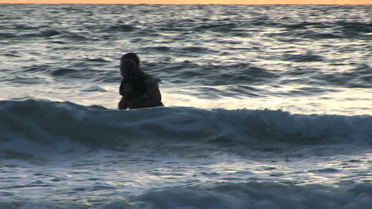 Father and son in waves