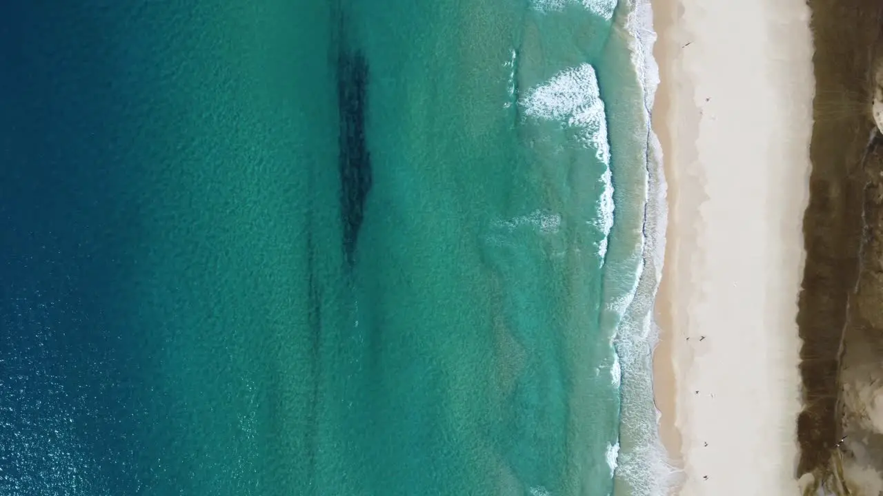 perfect turquoise water colors at the beach of tarifa in southern spain from above with a drone