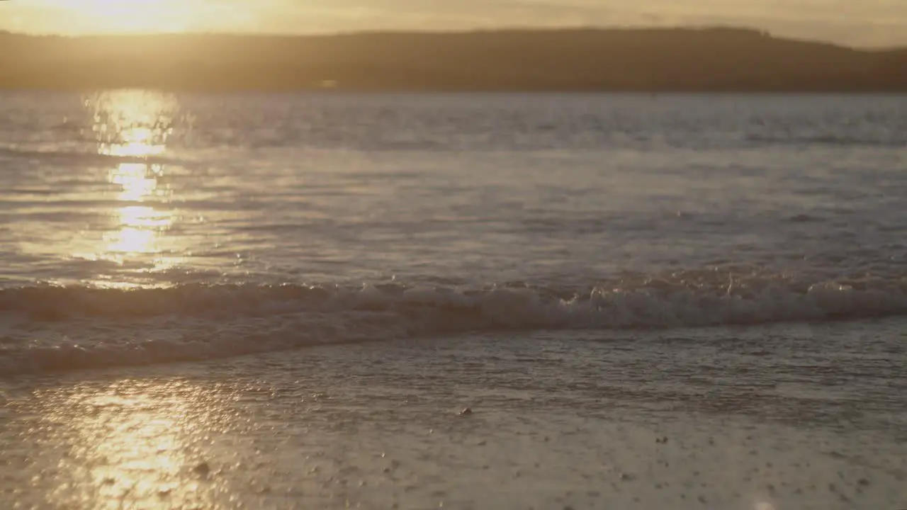 A beautiful golden sunset over the beach waves in Devon UK