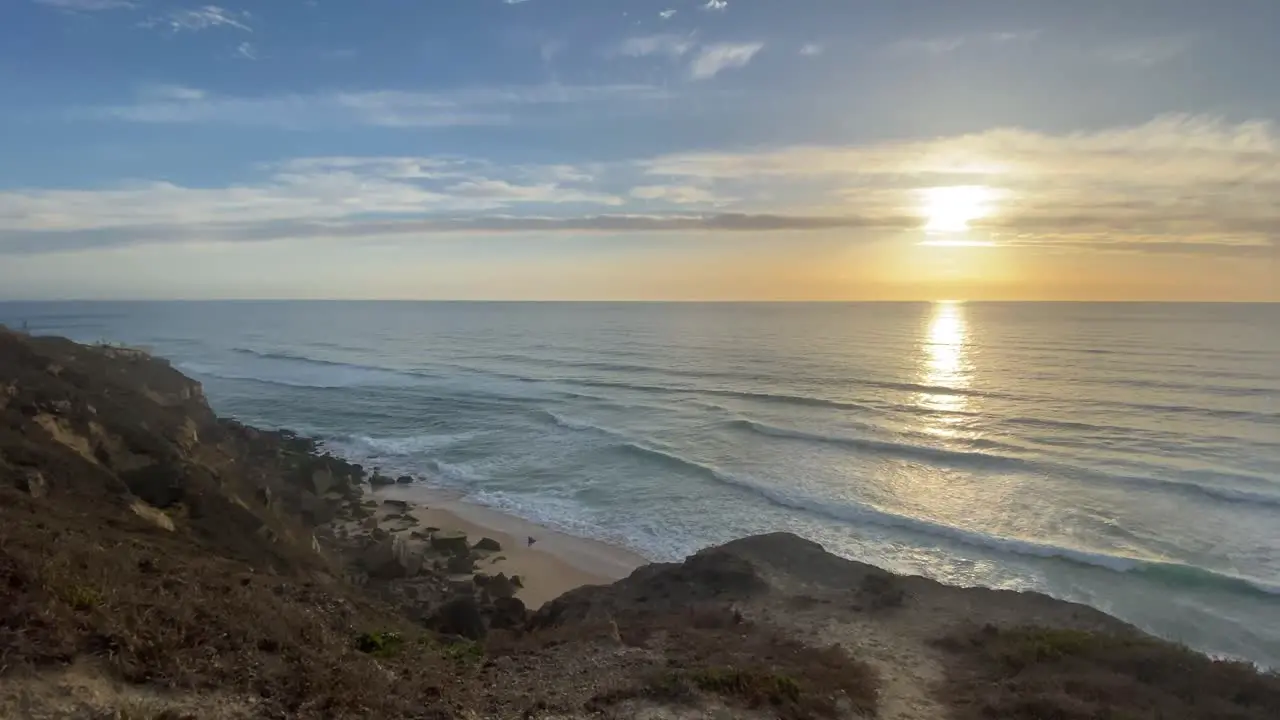 a cloudy beach in Portugal surrounded by sand and plants