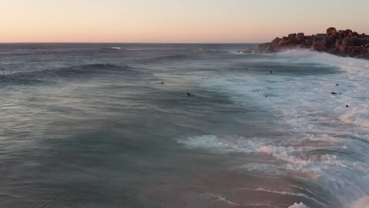 Surfers And Big Ocean Waves In Llandudno Cape Town South Africa aerial drone shot