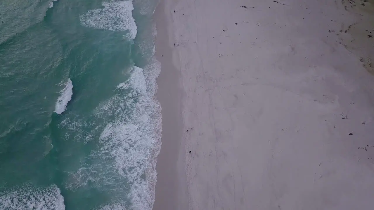 Aerial footage of beach and waves and mountains in South Africa Cape Town Noordhoek