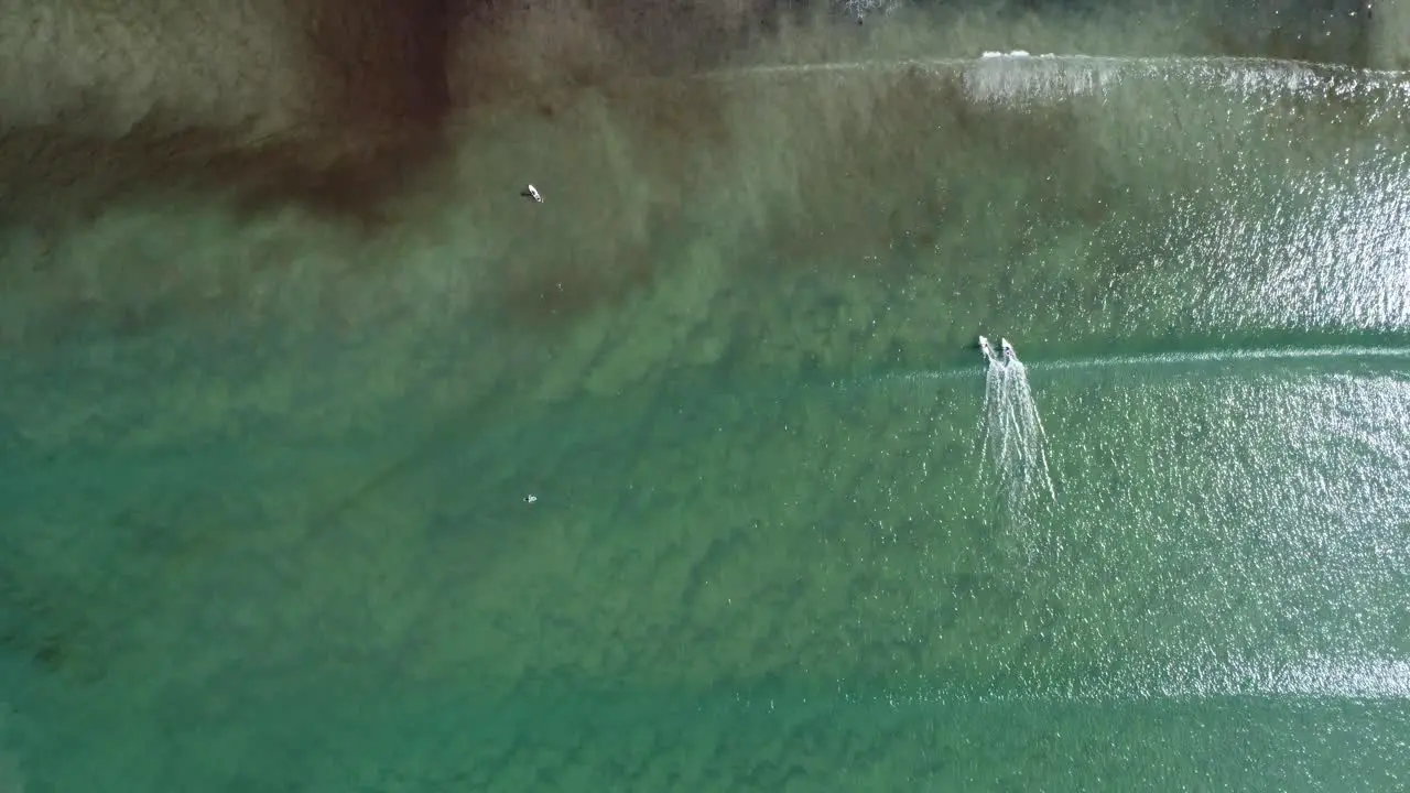 Two surfers surfing a wave at le goulien beach in brittany in france